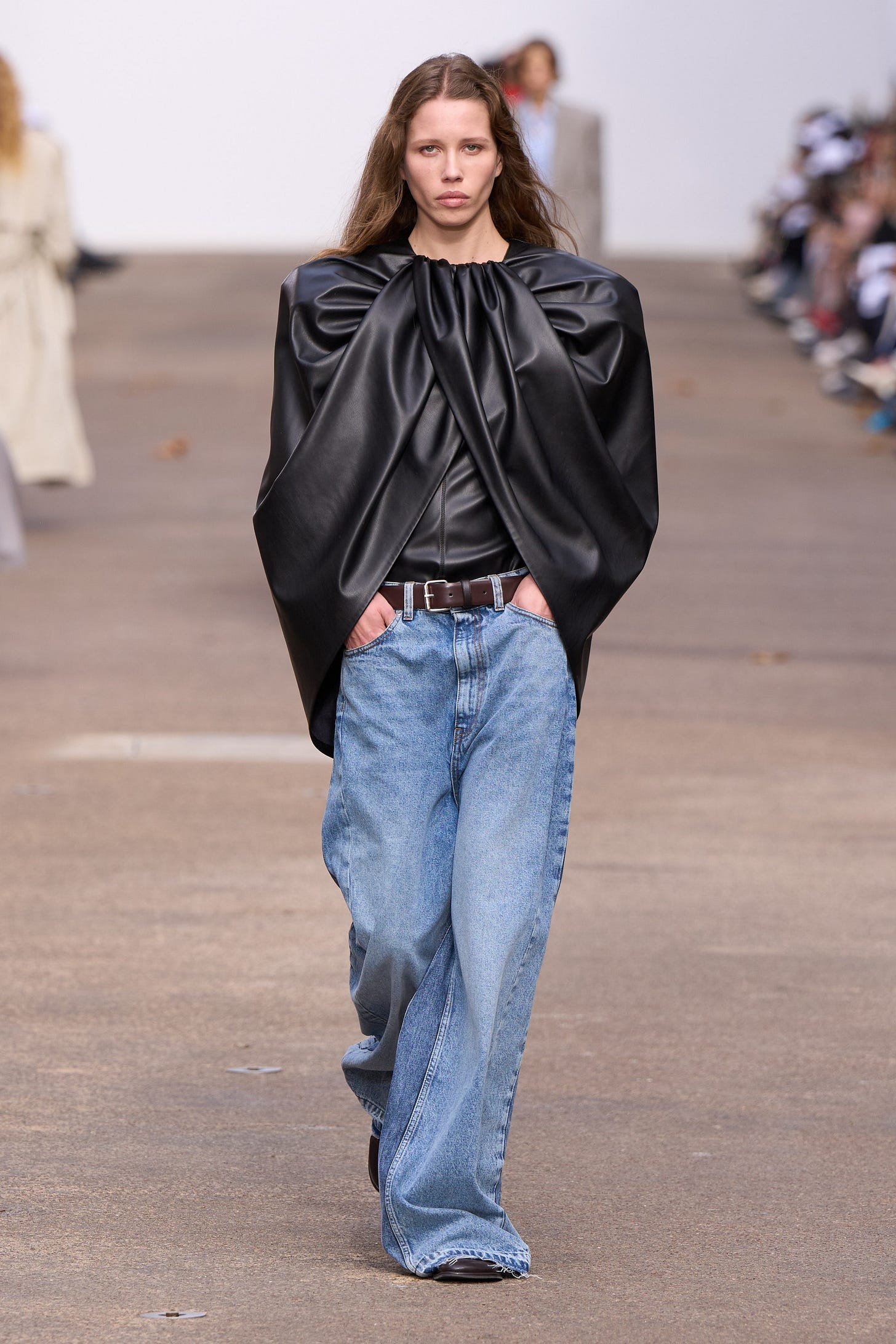Image may contain Clothing Pants Fashion Jeans Accessories Belt Adult Person Cape Coat Footwear and Shoe