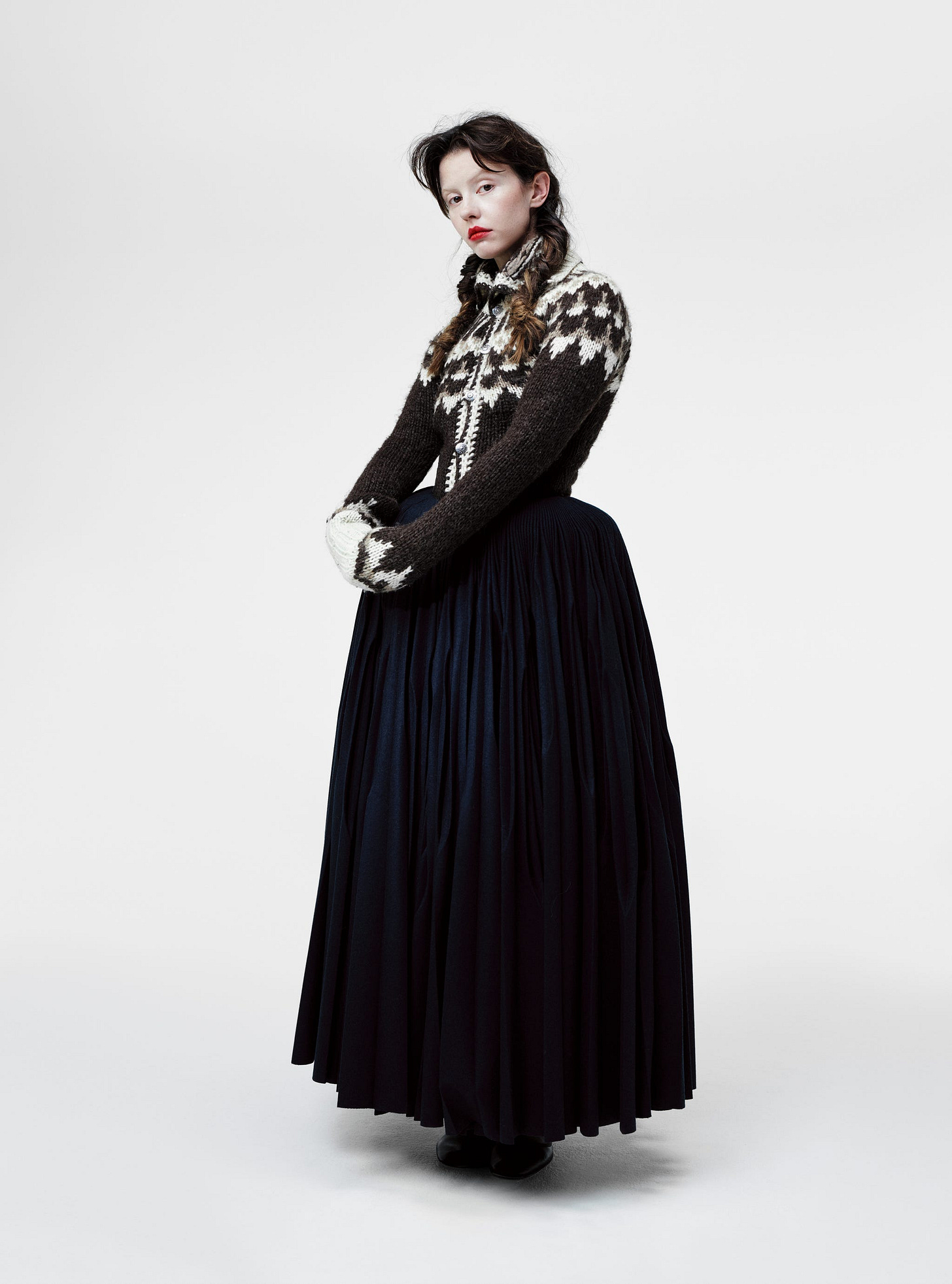 mia goth. cardigan, hodakova. skirt, alaÏa. shoes, repetto.