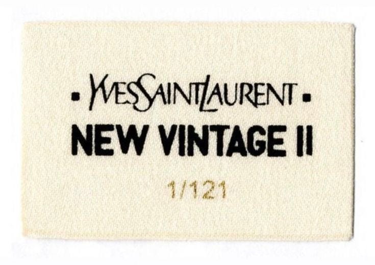 This may contain: a white label with black writing on it that says, yes saint laurent new vintage ii