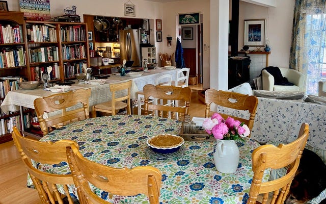 Large room with tables, lots of wooden chairs and bookcases in the background. Large room with tables, lots of wooden chairs and bookcases in the background.