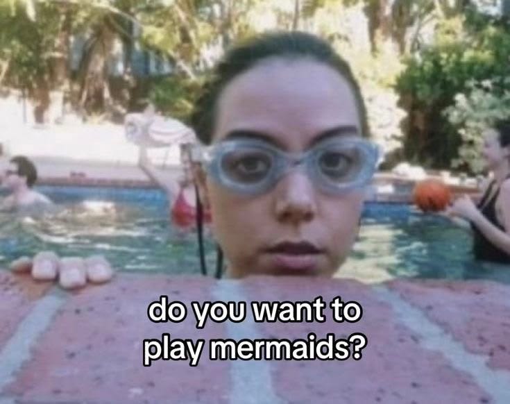 This may contain: a woman wearing goggles standing in front of a pool