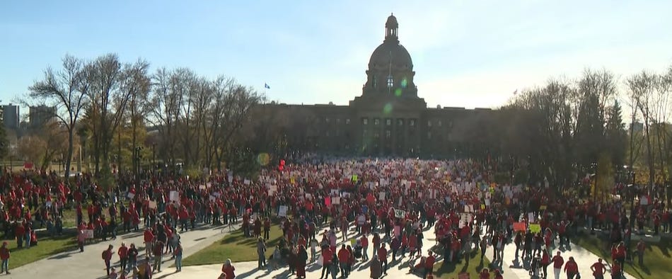 A large crowd in front of the Alberta legislature