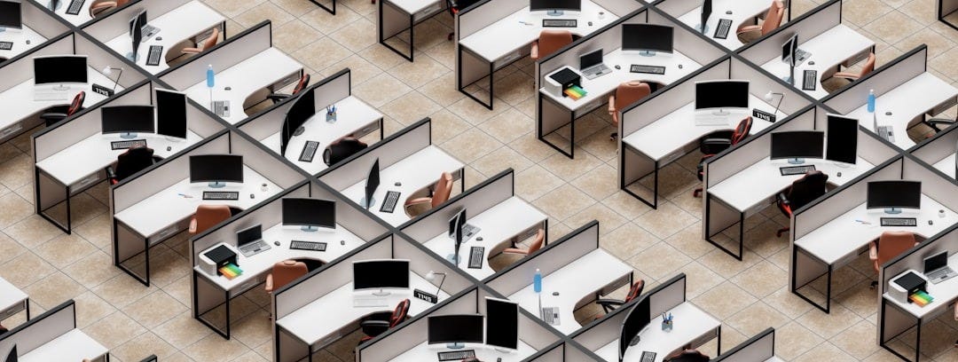 a room filled with lots of desks and computers a room filled with lots of desks and computers