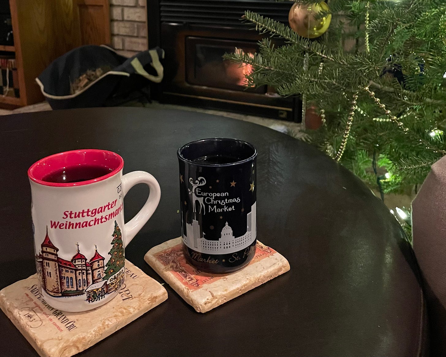 Picture shows two tea mugs by a christmas tree and fire Picture shows two tea mugs by a christmas tree and fire