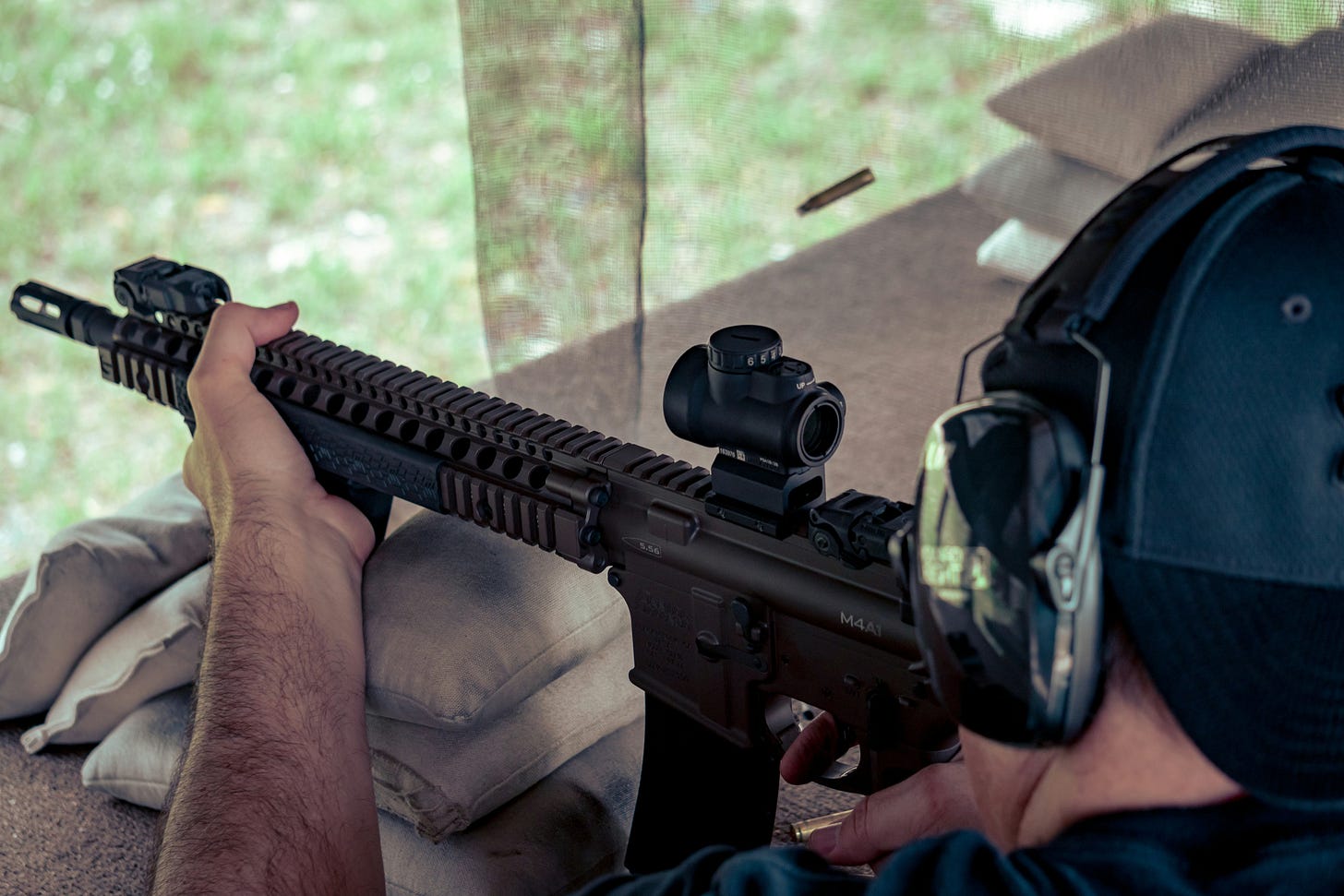 Photo of guy on a gun range firing his clients