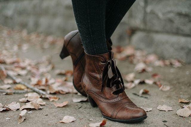 May be an image of boots and wingtip shoes