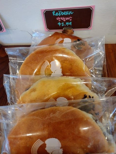 Bakery case, buns, interior of bakery with chandeliers