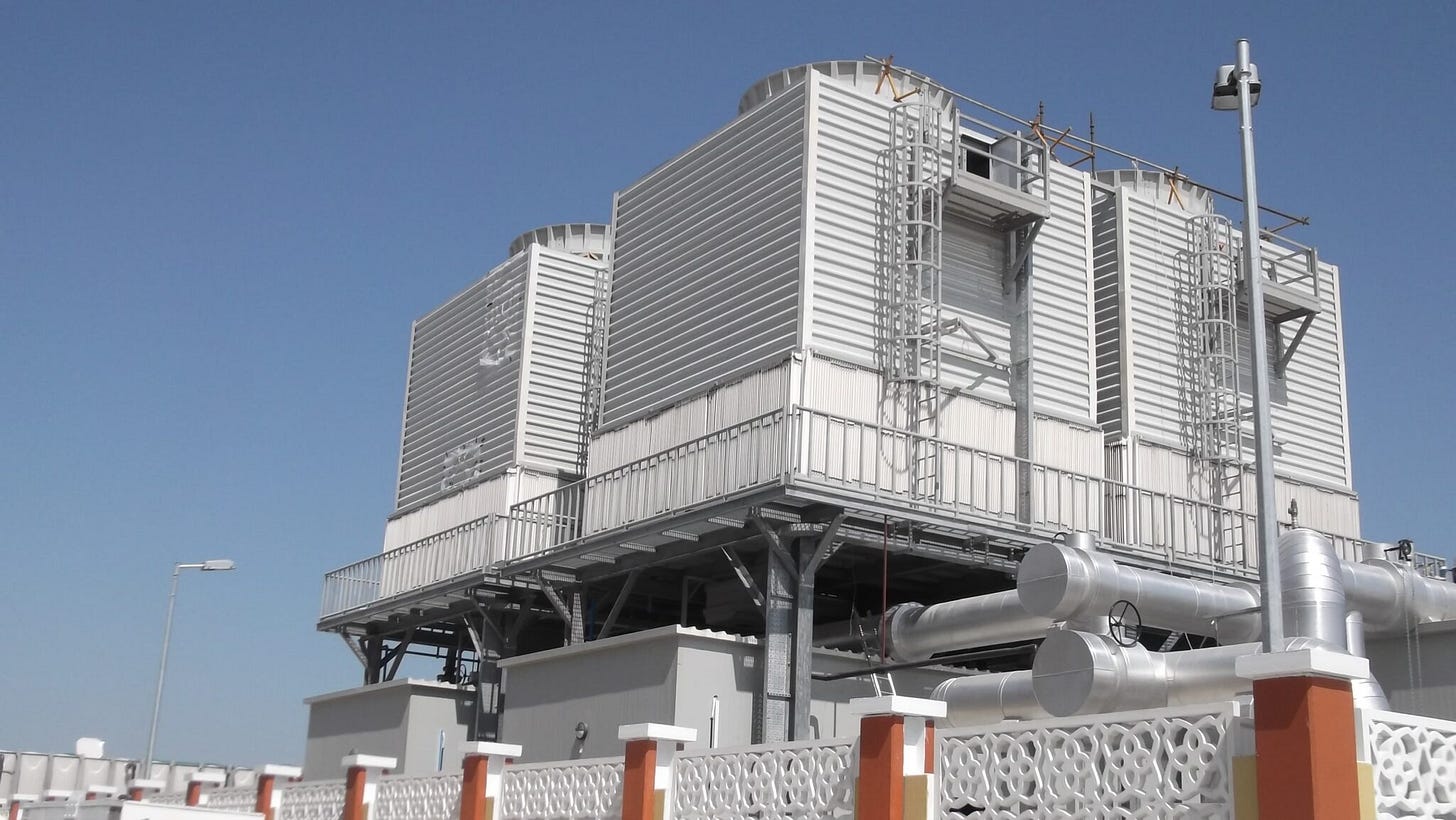 Data center cooling towers releasing water vapor, showing evaporative cooling system used to cool AI servers Data center cooling towers releasing water vapor, showing evaporative cooling system used to cool AI servers