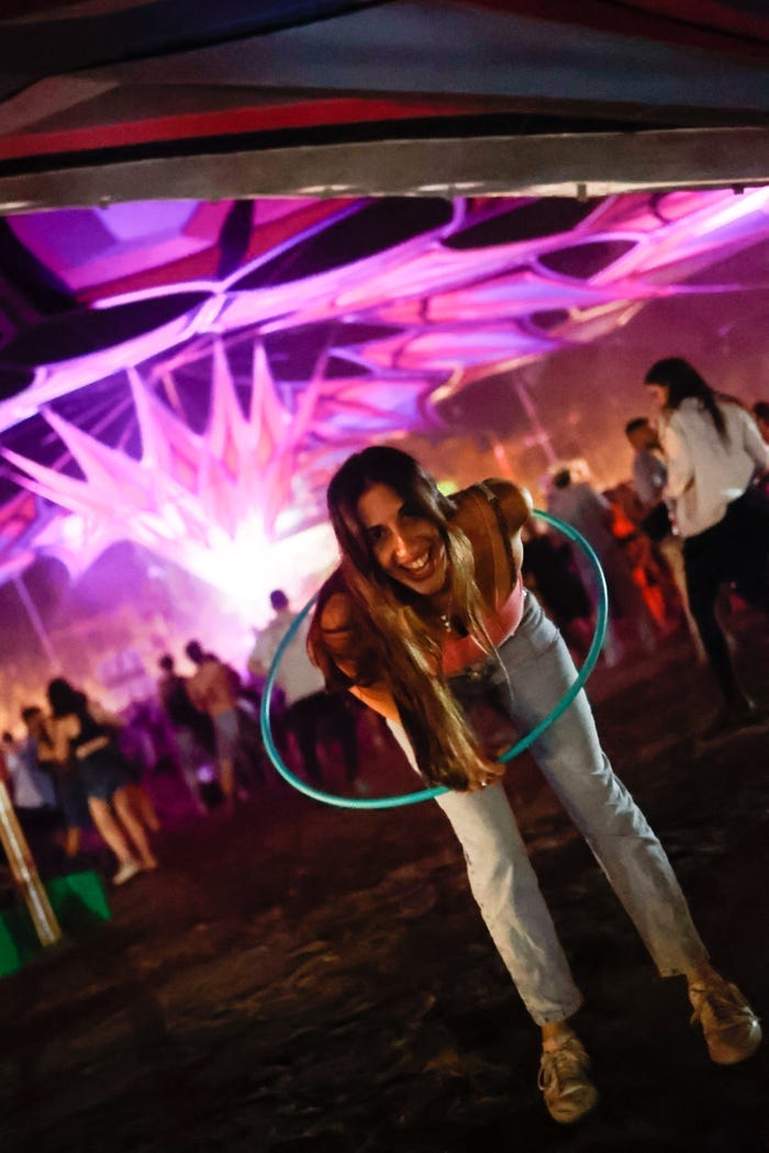 woman with hula hoop smiling at festival
