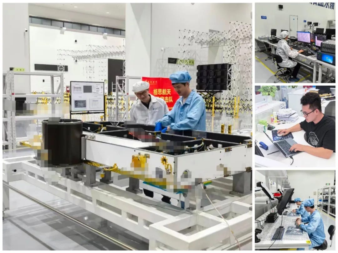 Technicians installing and testing hardware for a partially assembled Qianfan satellite.