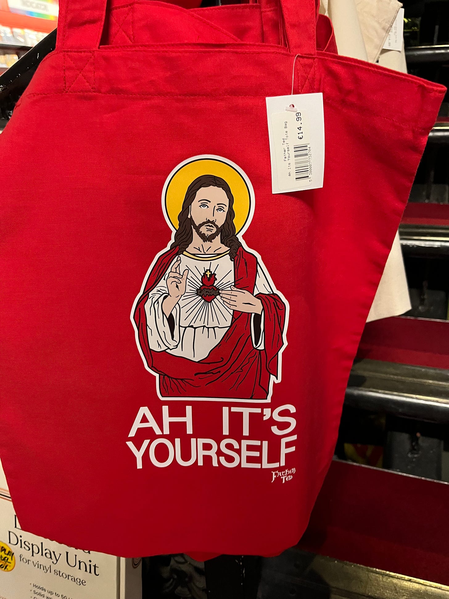 Red tote bag with a picture of Jesus that says "Ah it's yourself"