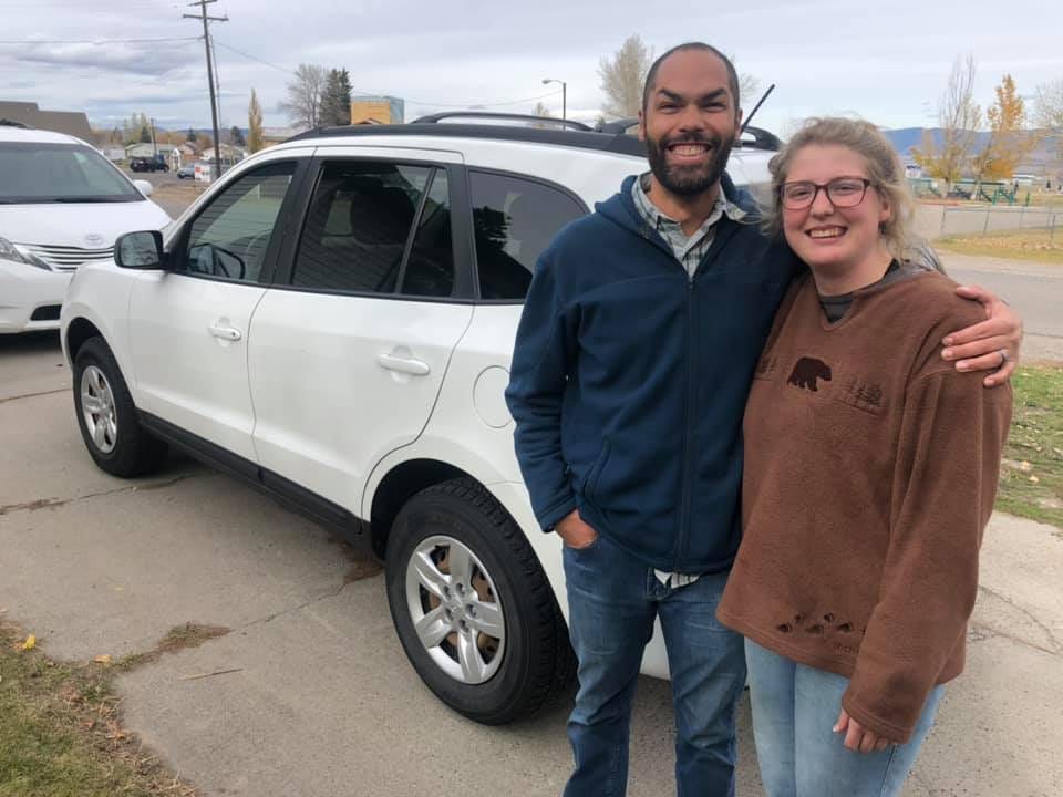 May be an image of 2 people, people standing, car and road