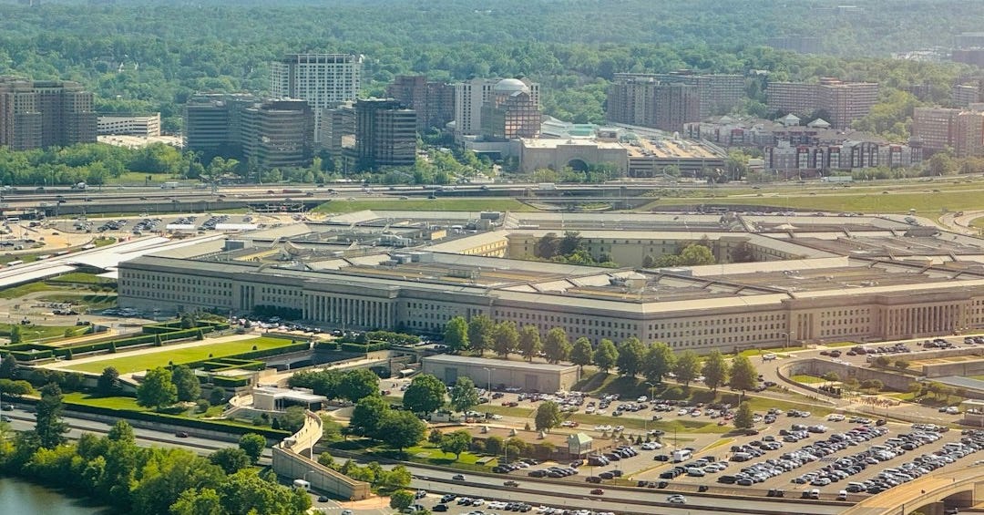 The pentagon building with surrounding parking lot and trees