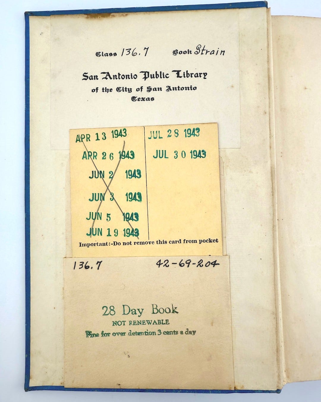 An open book from the San Antonio Public Library displaying a series of dates with various handwritten notes and stamps, alongside the text "Important: Do not remove this card from pocket" and "Date Book Not Renewable."