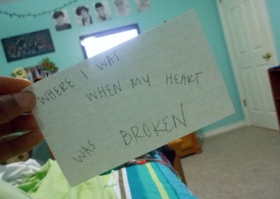a gallery of photos which contain 17-year-old Ari's hand holding flashcards in front of various locations. each flashcard reads "this is where I..." and is completed with the memory associated with the location