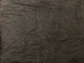 Scrumpled black tissue paper stuck on card.