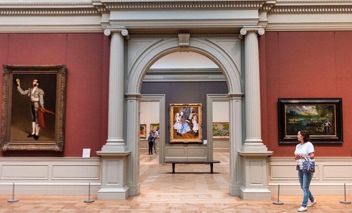 Visitors to the Metropolitan Museum of Art enjoy the art.