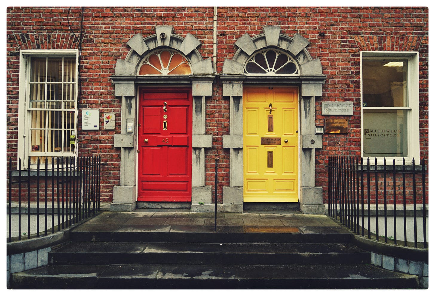 Two doors of different colors, immediately next to each other. Two doors of different colors, immediately next to each other.