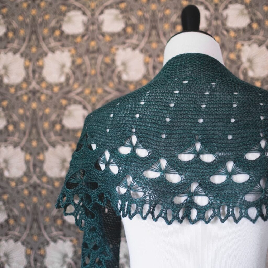 Tineola Shawl hand-knit by Kristin Lehrer, featuring the luxurious drape of Voolenvine Yarns' Gosling base. The shawl displays intricate lace patterns and delicate motifs, perfectly accentuated by the yarn's blend of superwash Merino, baby alpaca, and silk. Tineola Shawl hand-knit by Kristin Lehrer, featuring the luxurious drape of Voolenvine Yarns' Gosling base. The shawl displays intricate lace patterns and delicate motifs, perfectly accentuated by the yarn's blend of superwash Merino, baby alpaca, and silk.