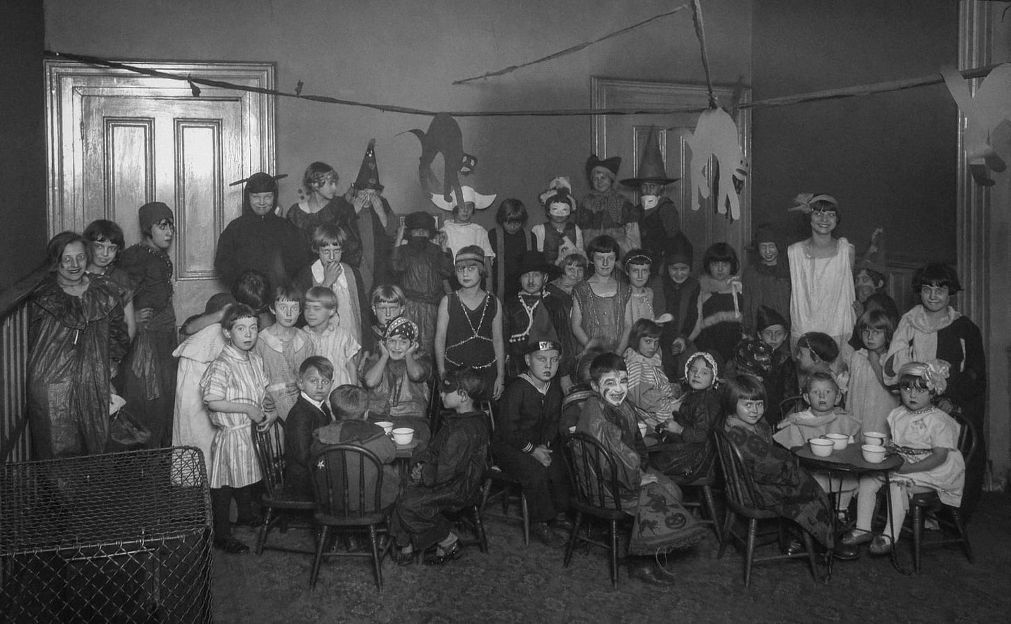 black and white vintage photo of a large group of children in costumes