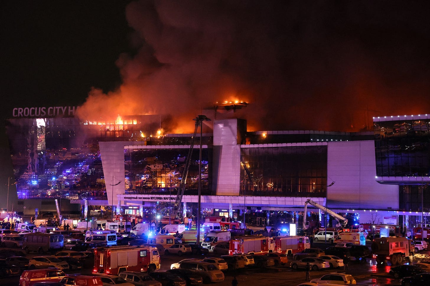 Emergency vehicles gather outside the burning Crocus City Hall concert venue near Moscow on Friday following what Russian officials said was a mass shooting.&nbsp;