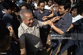 North Korean bodyguards watch over Norodom Sihanouk as he arrives at...  News Photo - Getty Images