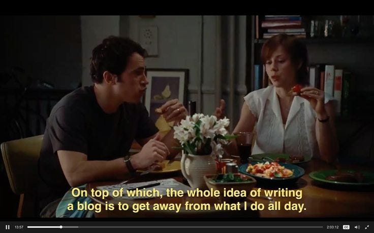 This may contain: a man and woman sitting at a table with food in front of them, eating