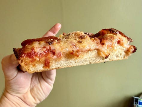 Pictures of pizza slices from Sid's