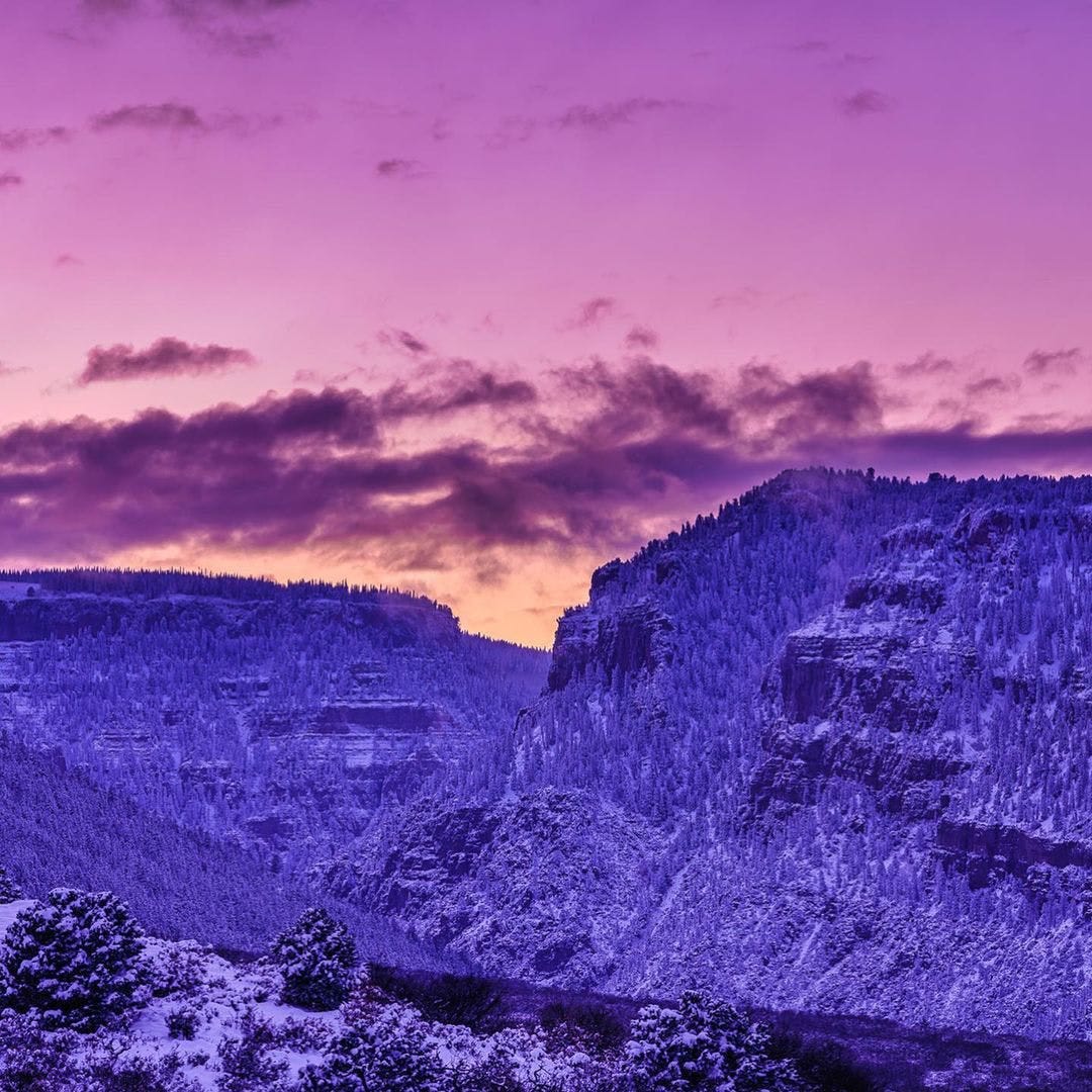 Purple ski over snowy mountains