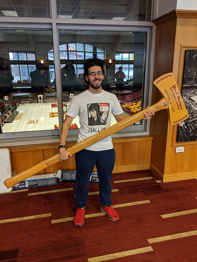 Eli holding Paul Bunyan's Ax, the Minnesota/Wisconsin football rivalry trophy, in February 2019 Eli holding Paul Bunyan's Ax, the Minnesota/Wisconsin football rivalry trophy, in February 2019