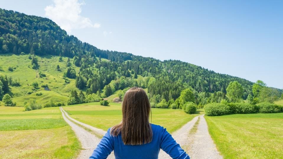 Woman stands at a crossroads thinking about how non-linear careers are the future. 