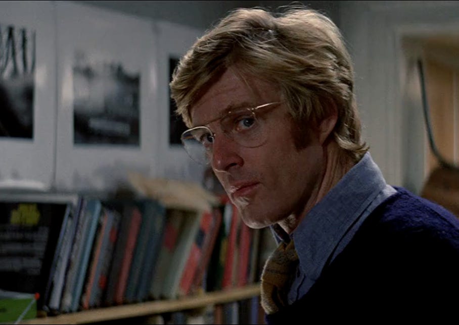 Film still depicting a CIA analyst surrounded by books, Three Days of the Condor (1975)