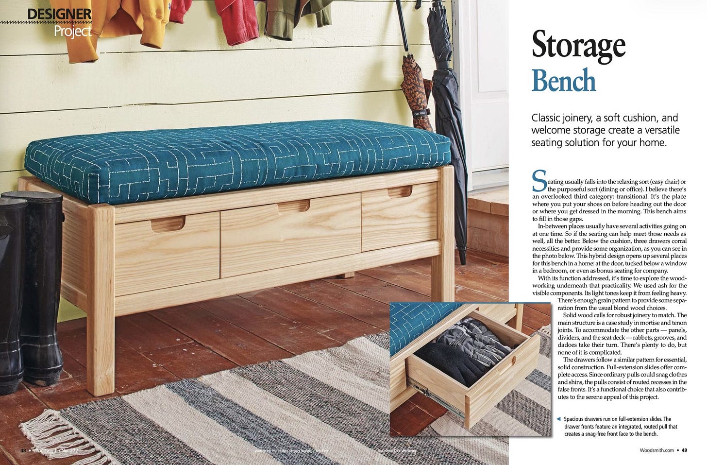 A cozy entryway setting with a light wood storage bench topped by a thick cushion upholstered in blue fabric with a white geometric stitch pattern. The bench has three pull-out drawers with cut-out handles, ideal for stashing shoes or small items. Above it, jacket sleeves in mustard yellow, red, and olive green hang from unseen hooks. An umbrella leans against a pale shiplap wall beside the bench, and a plush woven rug with gray, cream, and black stripes lies in front on rich brown hardwood flooring. A cozy entryway setting with a light wood storage bench topped by a thick cushion upholstered in blue fabric with a white geometric stitch pattern. The bench has three pull-out drawers with cut-out handles, ideal for stashing shoes or small items. Above it, jacket sleeves in mustard yellow, red, and olive green hang from unseen hooks. An umbrella leans against a pale shiplap wall beside the bench, and a plush woven rug with gray, cream, and black stripes lies in front on rich brown hardwood flooring.