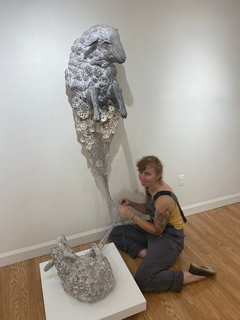 Installation views of a gallery with several artworks depicting sheep. All works are made of ceramic with fiber attachments connecting them together.