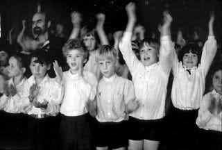 an audience of cheering children 