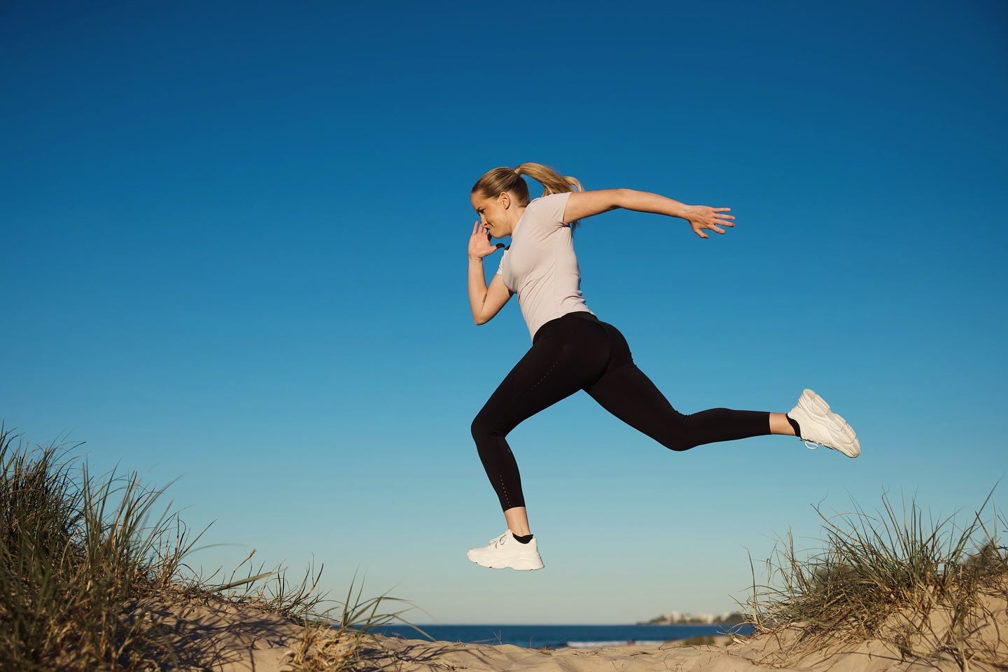 Image of Fran Hurndall running near the beach