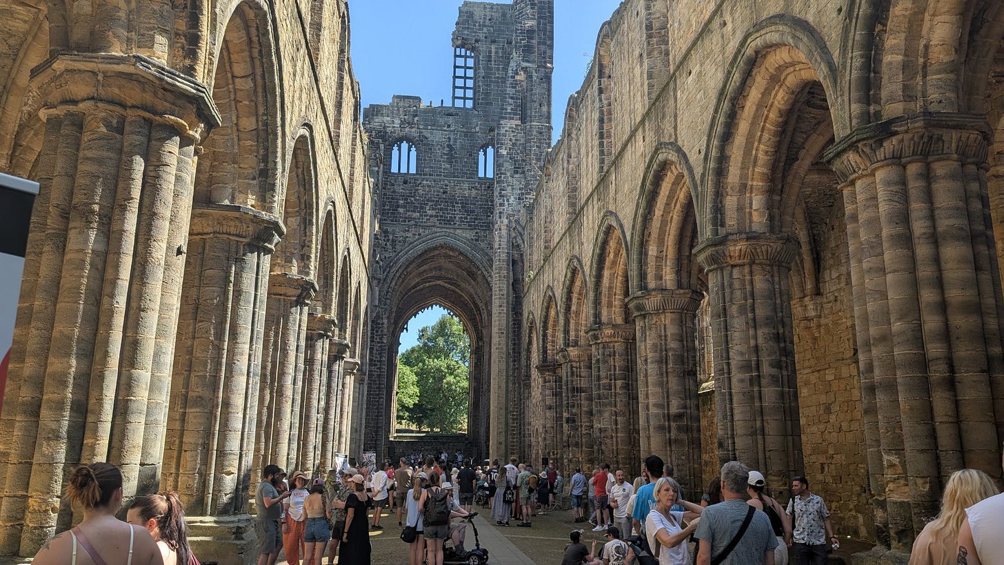 A view of the main body of the church, with pillars on either side and the ruins open to the sky