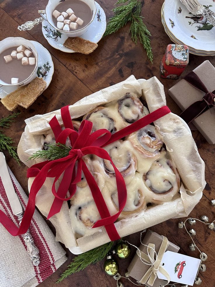 This may contain: a box filled with food sitting on top of a table next to plates and cups This may contain: a box filled with food sitting on top of a table next to plates and cups