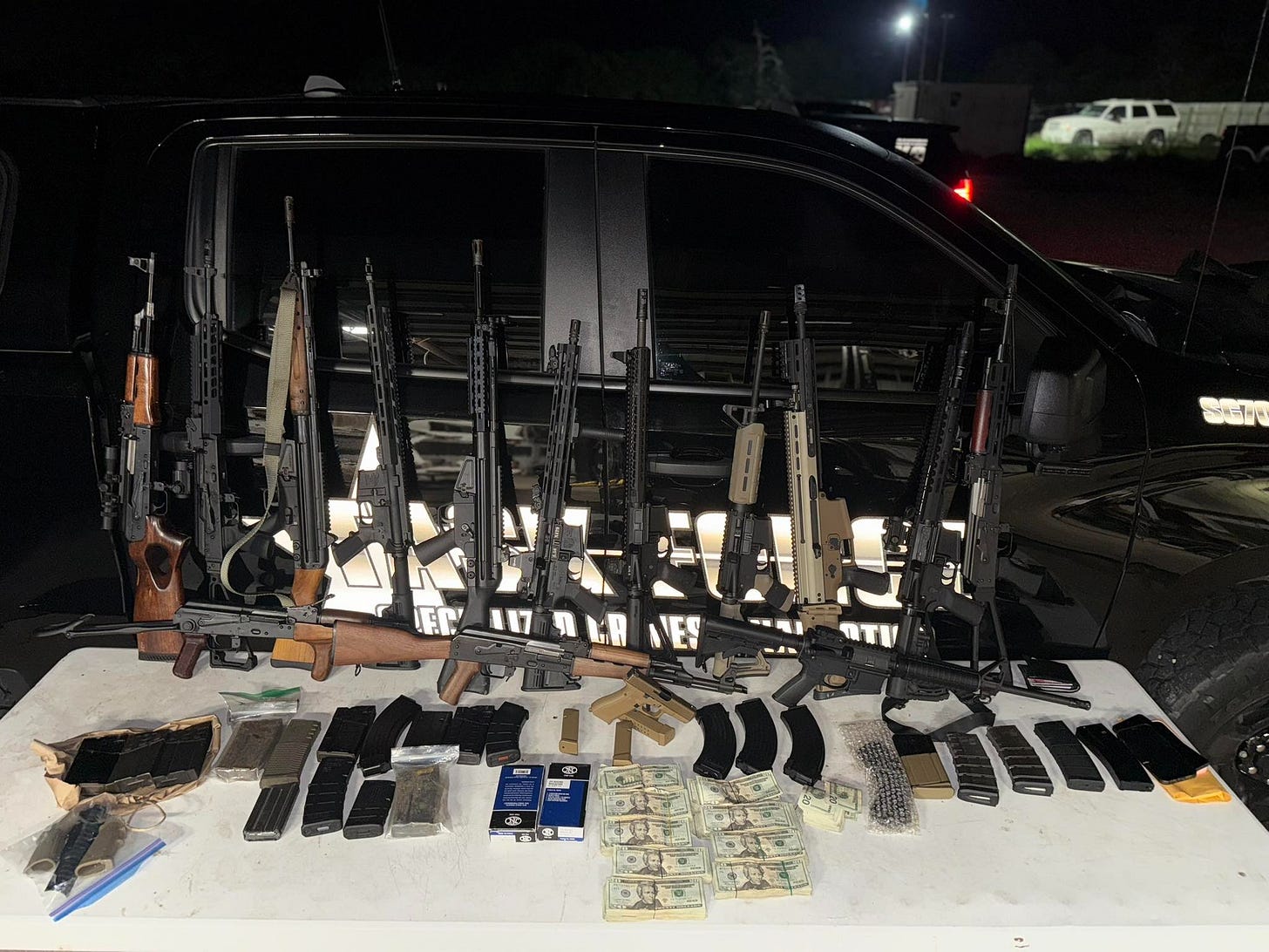 This small arsenal of cartel guns, ammo (along with cash) was seized last week from a cartel smuggler. 