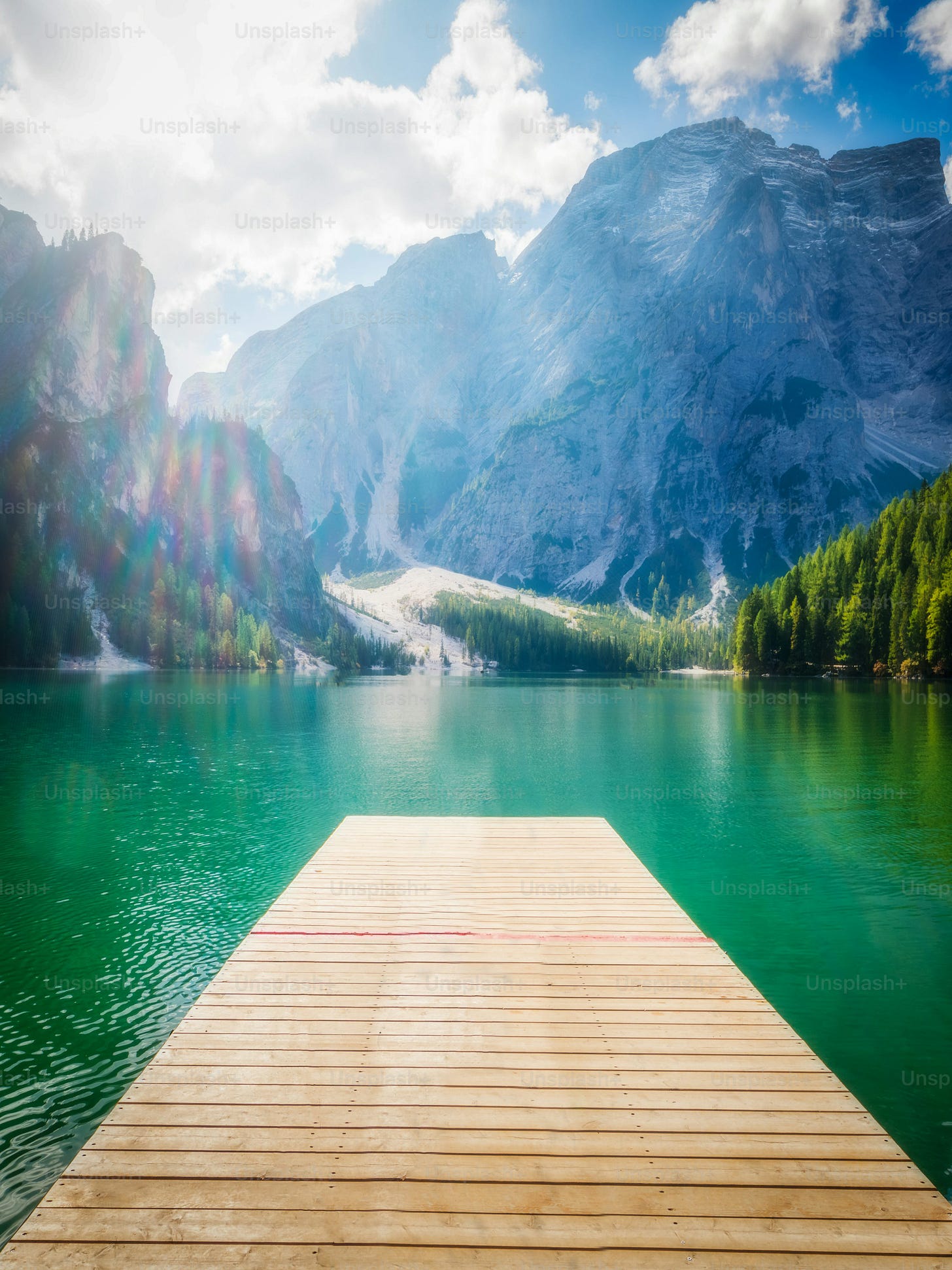 Braies Lake in Dolomites mountains Seekofel in background, Sudtirol, Italy. Lake Braies is also known as Lago di Braies. The lake is surrounded by the mountains which are reflected in the water. Braies Lake in Dolomites mountains Seekofel in background, Sudtirol, Italy. Lake Braies is also known as Lago di Braies. The lake is surrounded by the mountains which are reflected in the water.