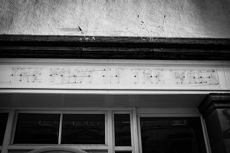 Black and white photographs of The foot of the Walk after it closed. The sign has been removed.