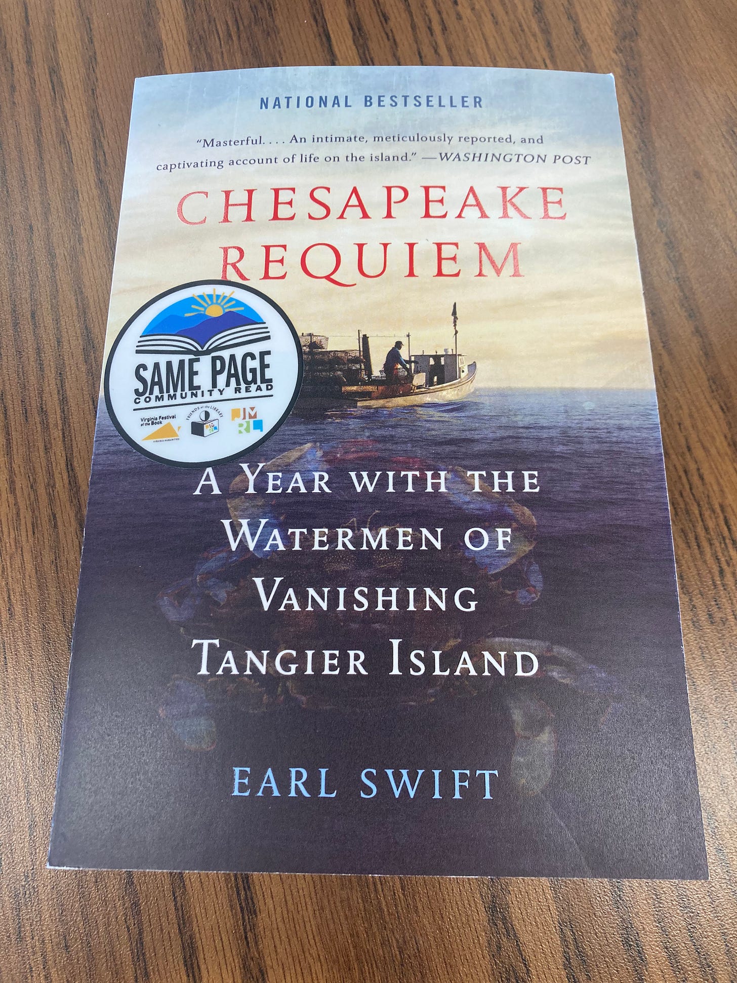 Paperback copy of Chesapeake Requiem: A Year with the Watermen of Vanishing Tangier Island," by Earl Swift, with sticker that reads "Same Page Community Read." Paperback copy of Chesapeake Requiem: A Year with the Watermen of Vanishing Tangier Island," by Earl Swift, with sticker that reads "Same Page Community Read."