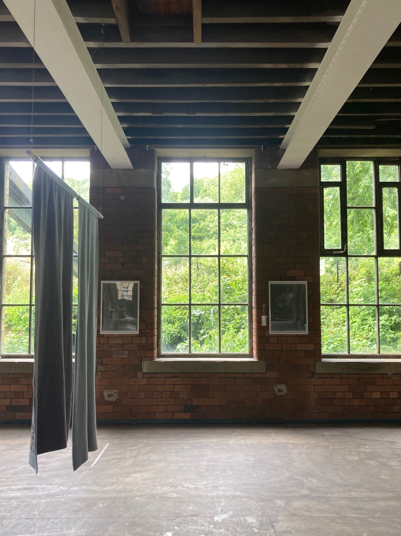A room with a brick wall and windows

AI-generated content may be incorrect.