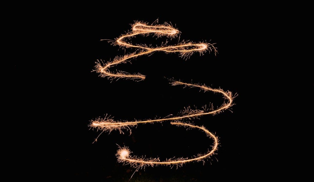 a long exposure of a sparkler in the dark a long exposure of a sparkler in the dark