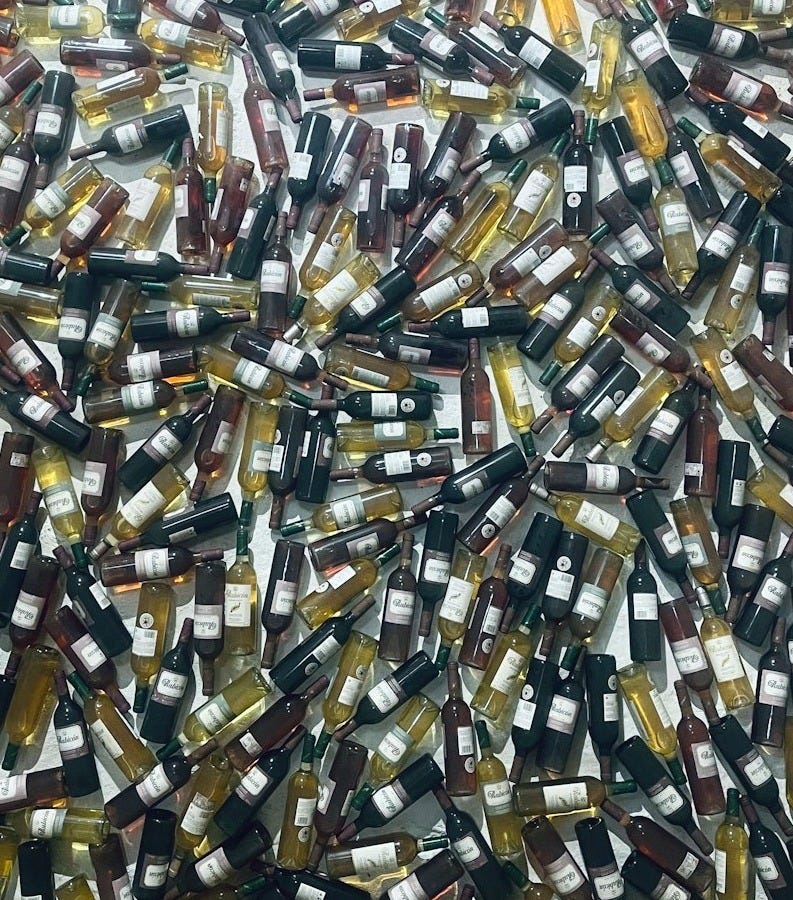 a large amount of wine bottles are stacked together a large amount of wine bottles are stacked together