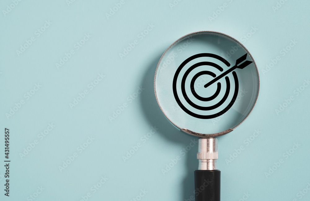 Target board inside of magnifier glass for focus business objective on blue  background and copy space. Stock Photo | Adobe Stock