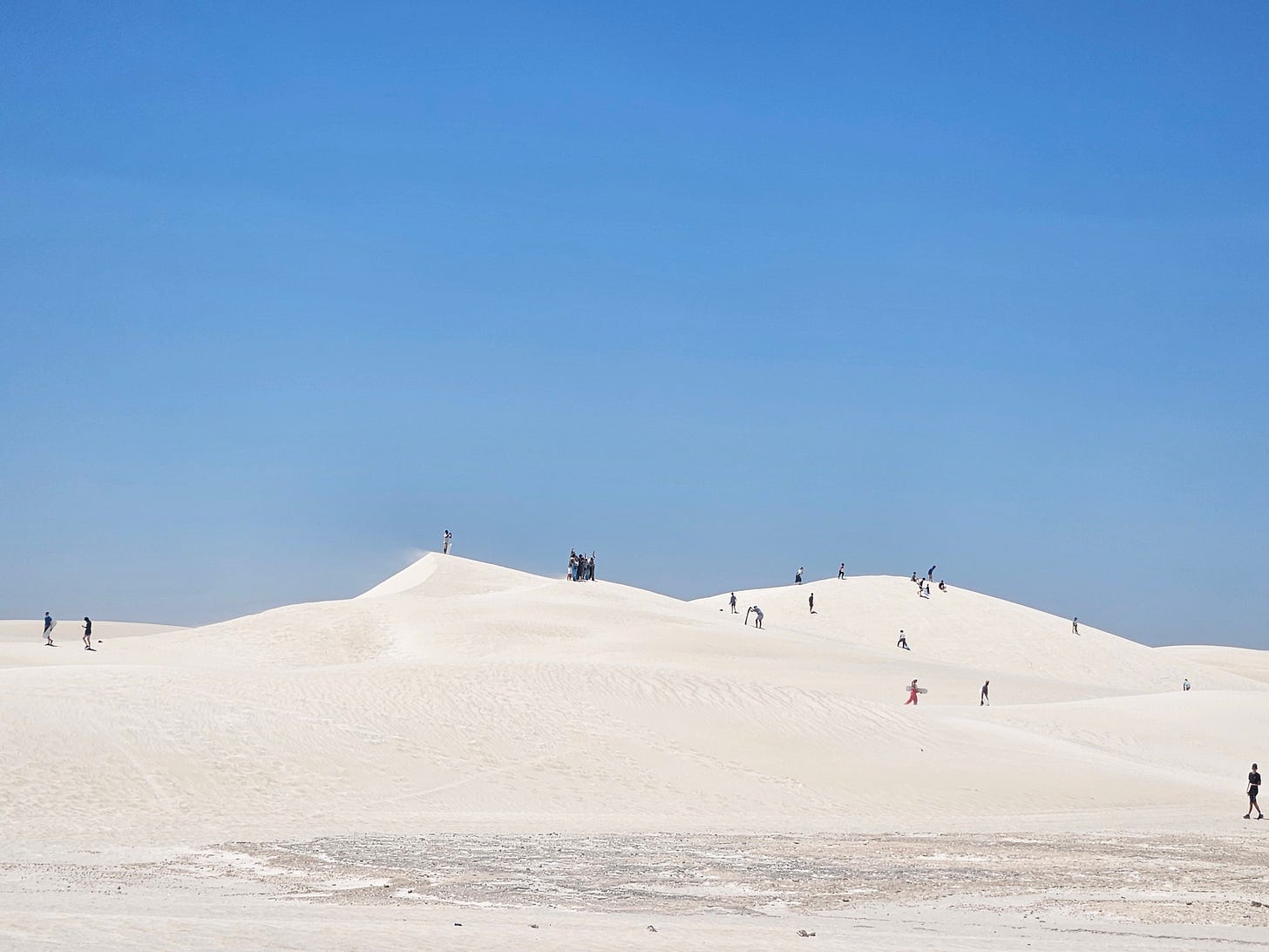 Visitors enjoying the powdery white sand dunes at Lancelin
