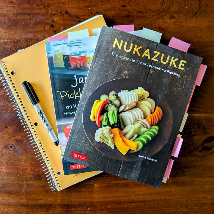 Japanese cookbooks with colorful sticky notes marking multiple pages.