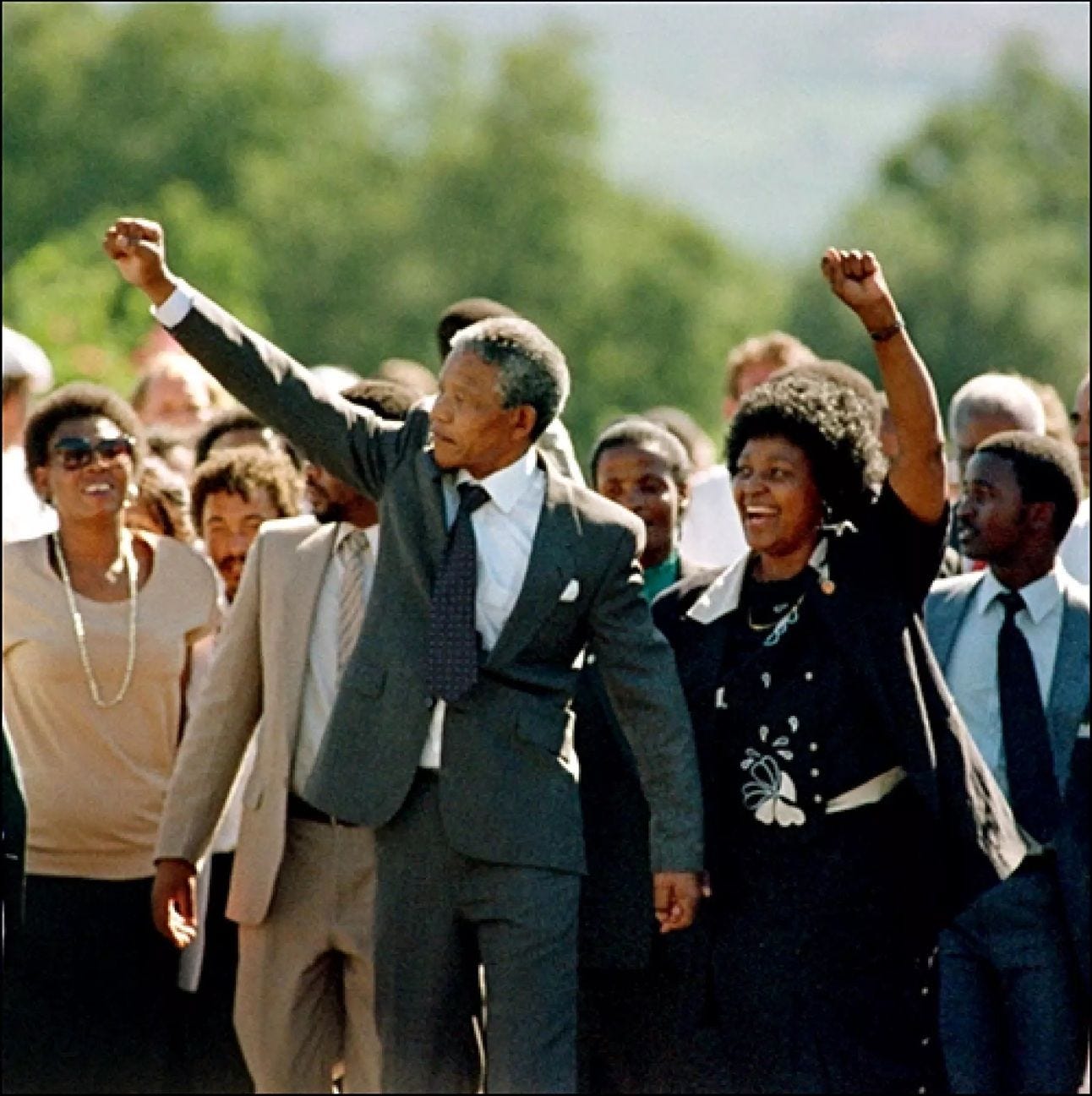 Nelson Mandela leads a crowd marching with his right fist raised following his release from Robben Island prison in 1990