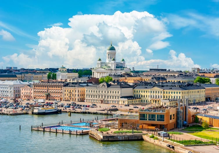 A panoramic view of the centre of Helsinki with blue skies and a white cloud above the white cathedral in the centre. A panoramic view of the centre of Helsinki with blue skies and a white cloud above the white cathedral in the centre.